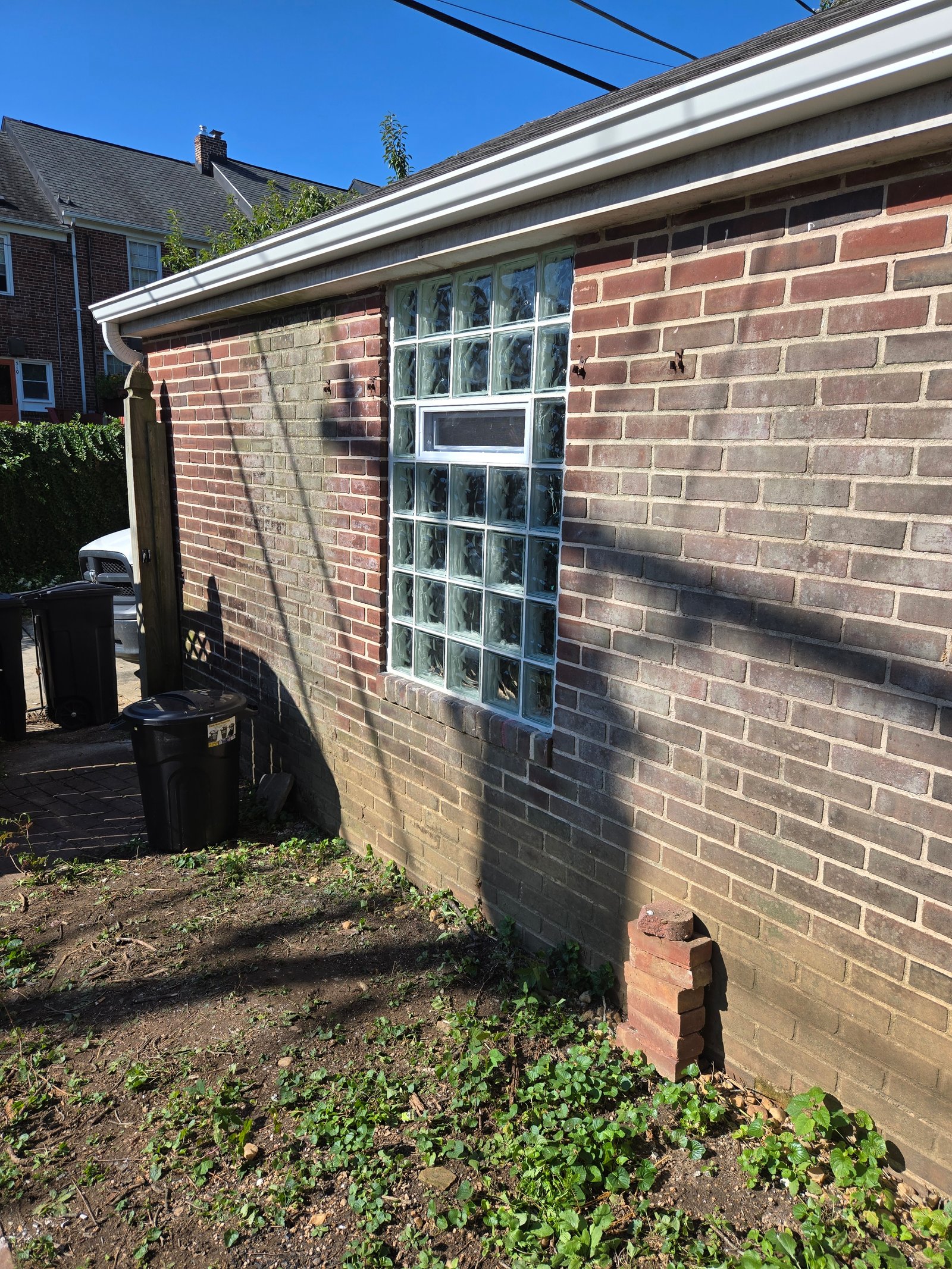 Glass block window with vent in brick wall